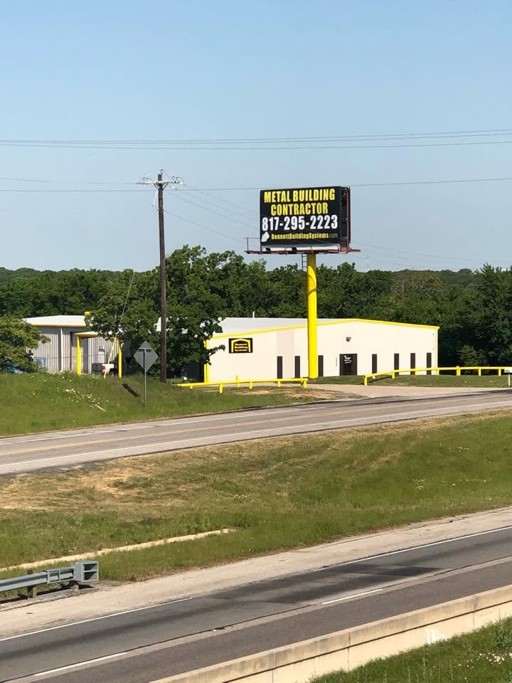 Historical photograph of the Bennett Building Systems building and roadside sign in Burleson