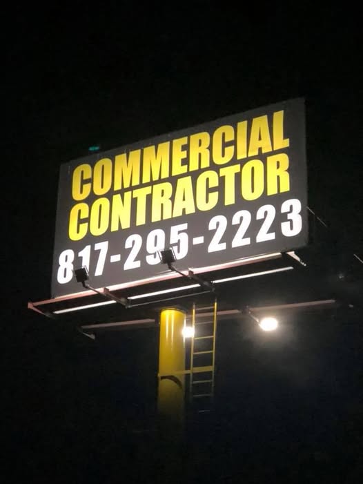 Historic Bennett commercial contractor sign photographed at night, displaying the former phone number